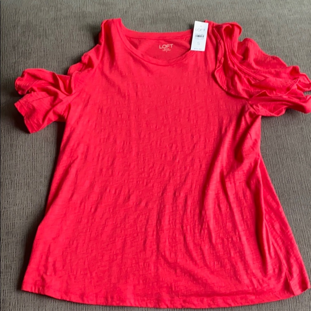 Bright pink peak a boo shoulder top.